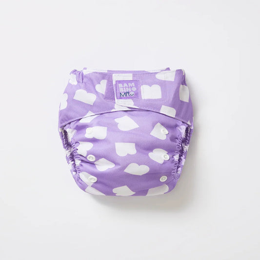 Purple diaper with white heart pattern on a light gray background. bambino mio reusable nappy